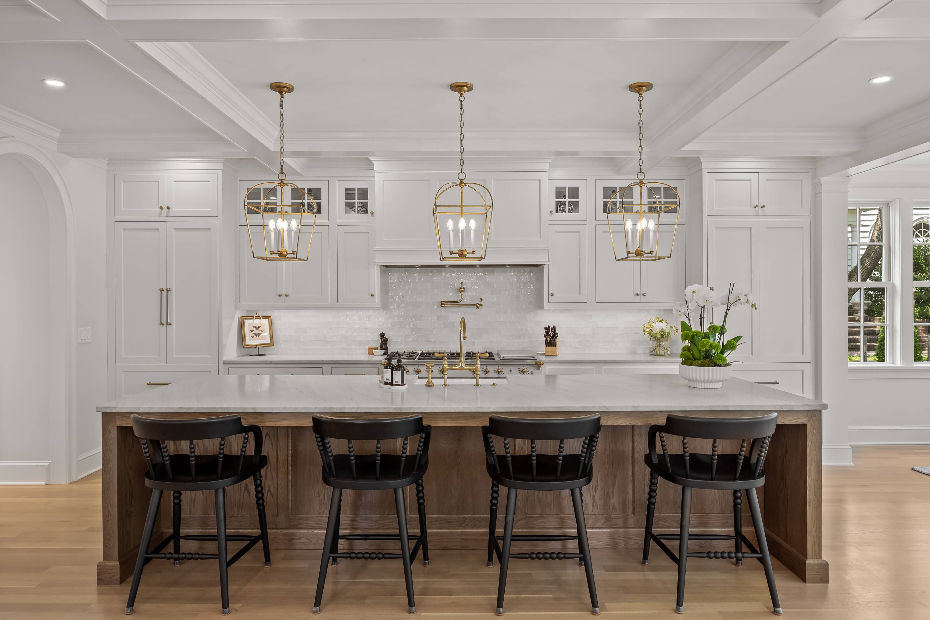 Kitchen upper cabinets with a customized vent hood in with a light colored wood, plain sawn white oak with a matte french biscuit finish.